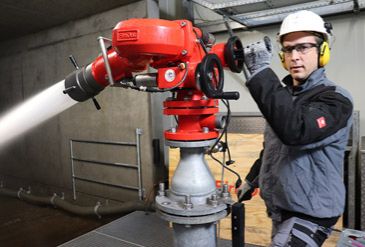 FireDos service team member operating a fire monitor