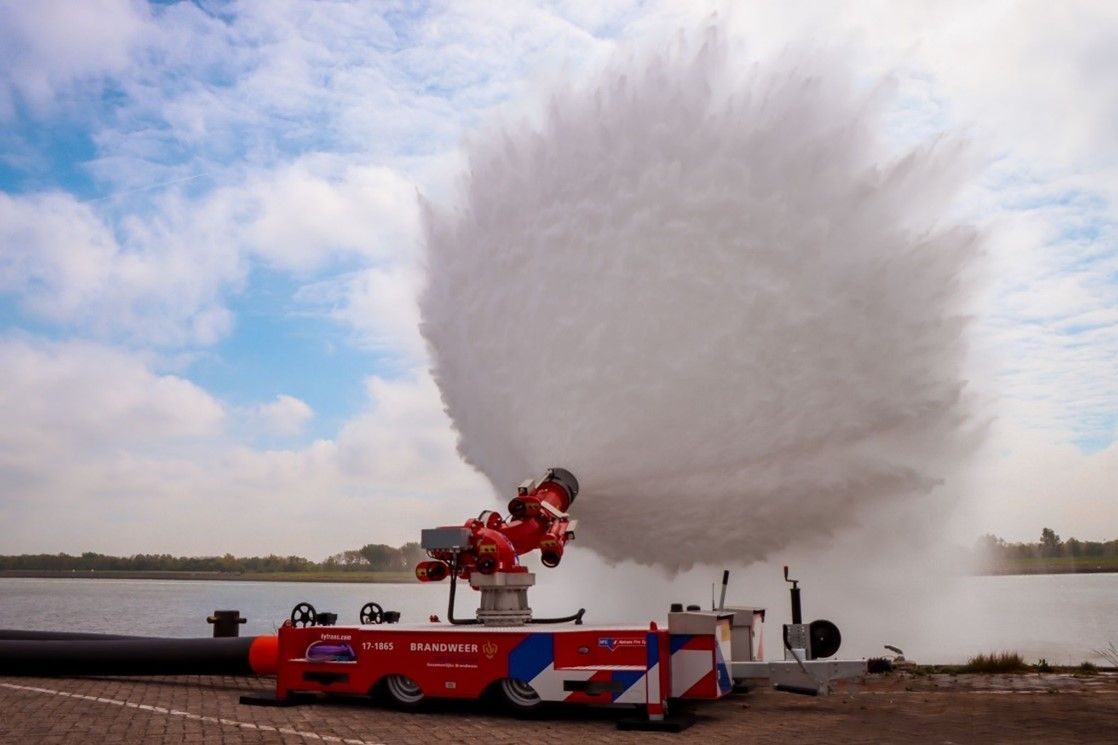 M9 fire monitor on a trailer generating an enormous, wide water spray plume.