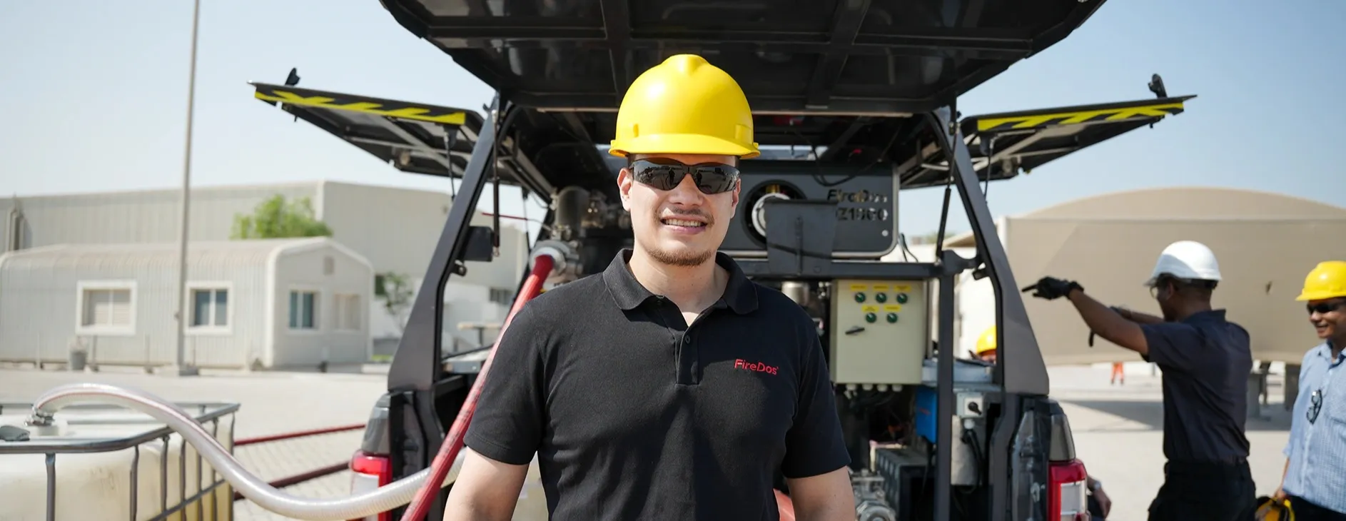 Jean-David Ly, wearing a helmet and standing in front of a car